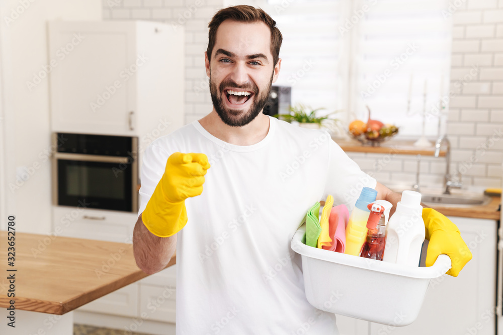 Positive man househusband indoors. Positive man househusband indoors.