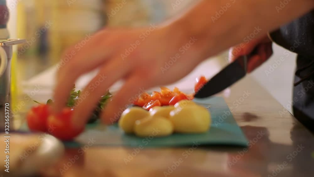 Close up view at chef cuts the vegetables and prepares the meal in the restaurant Close up view at chef cuts the vegetables and prepares the meal in the restaurant