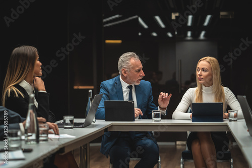 The people sitting at the table on business conference photo