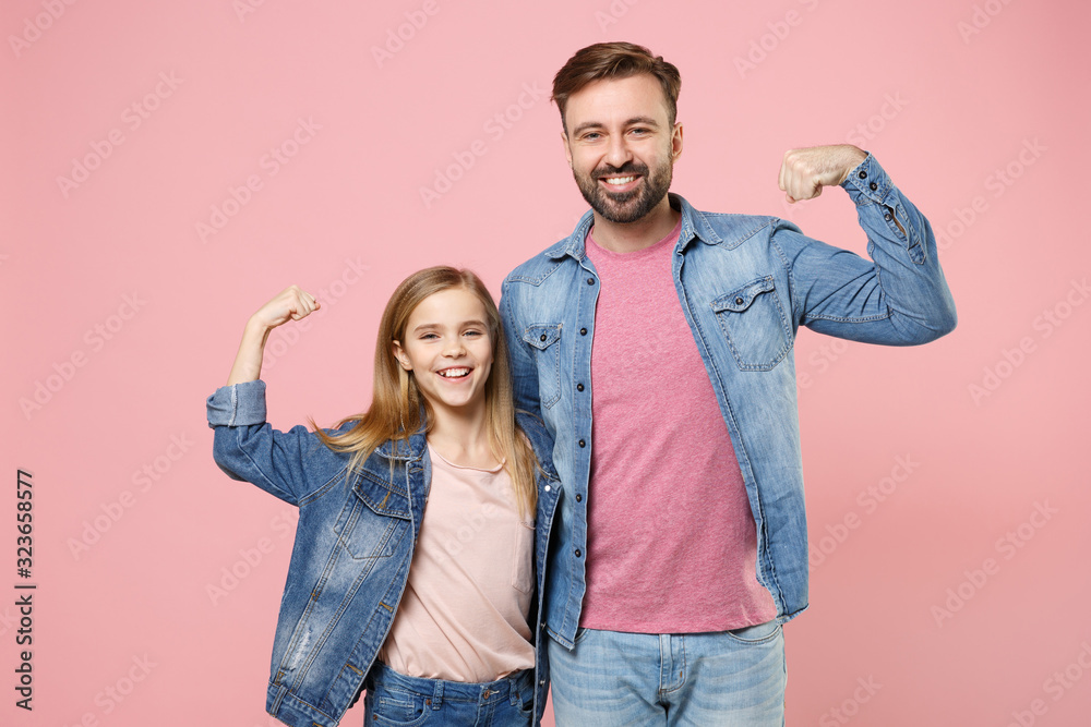 Obraz premium Smiling bearded man in casual clothes have fun with child baby girl. Father little kid daughter isolated on pastel pink background. Love family parenthood childhood concept. Showing biceps, muscles.