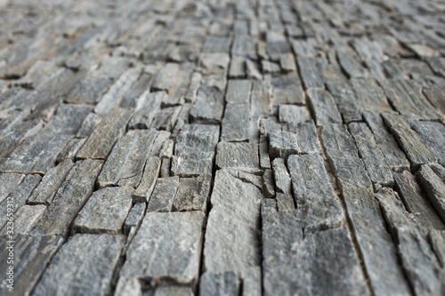 limestone wall in small rectangular blocks, selective focus, for background