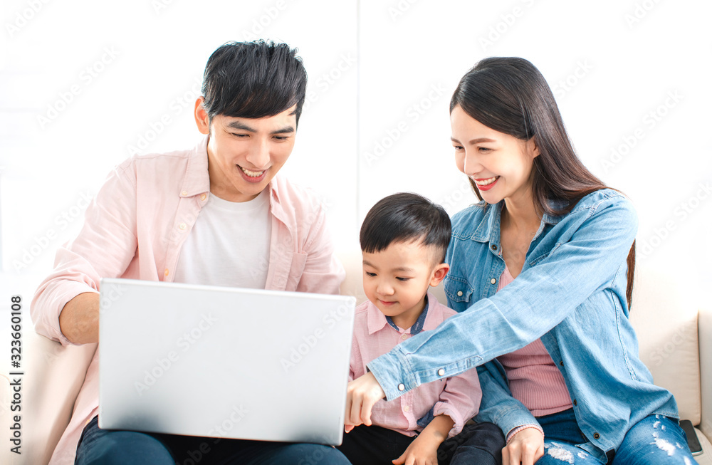 happy family watching the laptop on sofa happy family watching the laptop on sofa