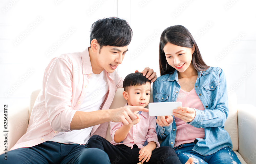 happy family watching the smart phone  on sofa