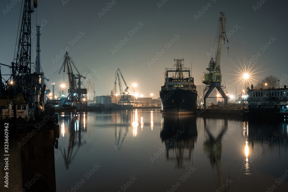 night port on the river with a large ship and cranes