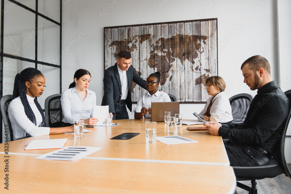 Group of happy young business people in a meeting at modern office. Multi-Ethnic Group Of Business People In Office