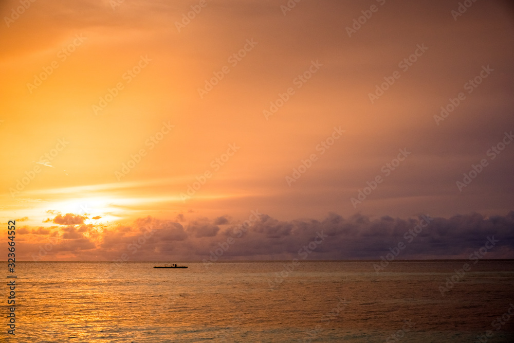 sunset in a beach in maldives islands
