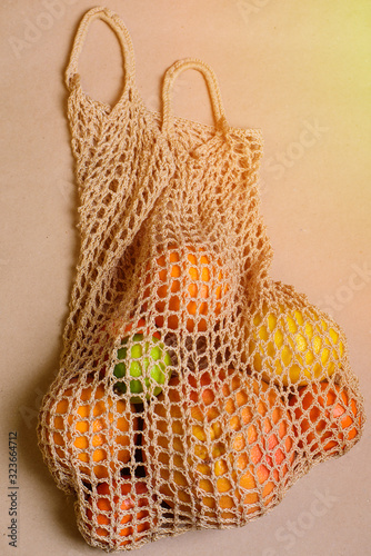 Fresh lemon, oranges, grapefruit and lime in string bag.