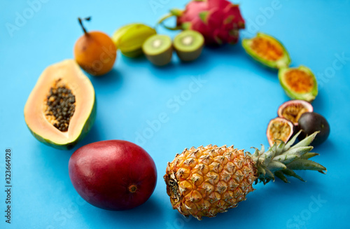 food  summer and healthy eating concept - different exotic fruits on blue background