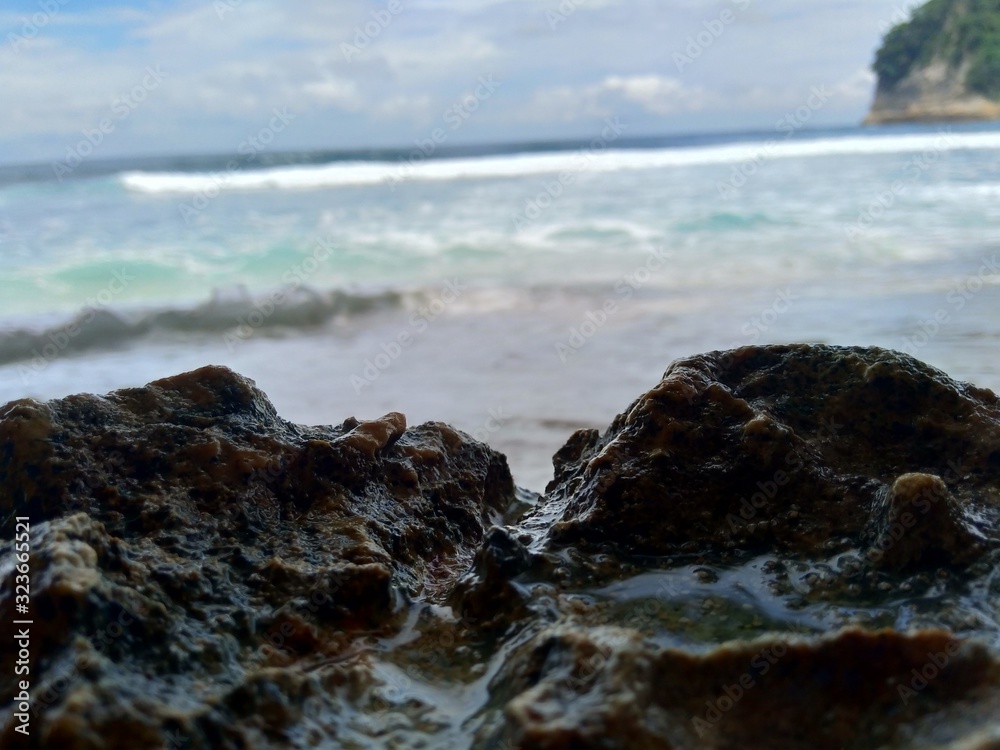 Beach with rocks, waves and blue sky. The beautiful Sanggar beach in Tulung Agung, East Java, Indonesia. Beach with rocks, waves and blue sky. The beautiful Sanggar beach in Tulung Agung, East Java, Indonesia.