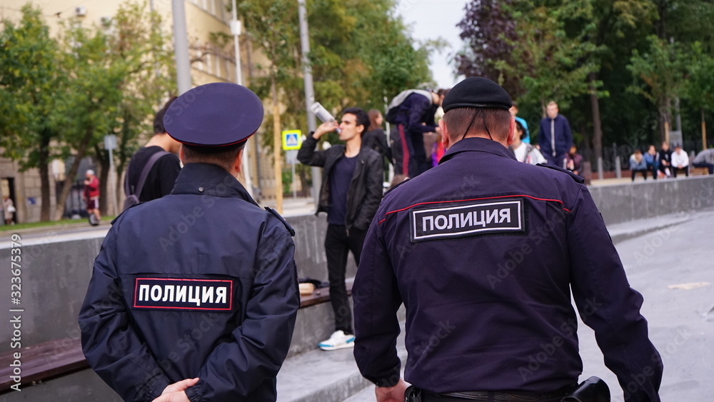 Police officers going towards young man with the bottle Police officers going towards young man with the bottle