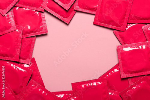 Condoms frame on pastel paper background with copy-space top view