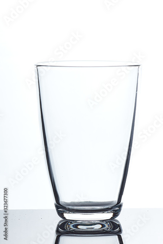 set of glass empty glasses and goblets on a gray-white background