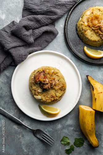Mofongo, mashed  boiled plantains with porc meat, onion. Puerto Rico.  Amazonian cuisine, Peru, Cuba, Fufu de platano, tacaho photo