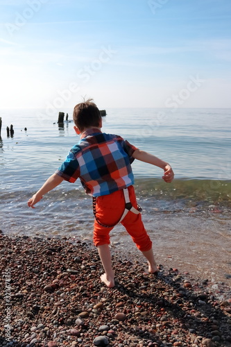 boy plays by the sea