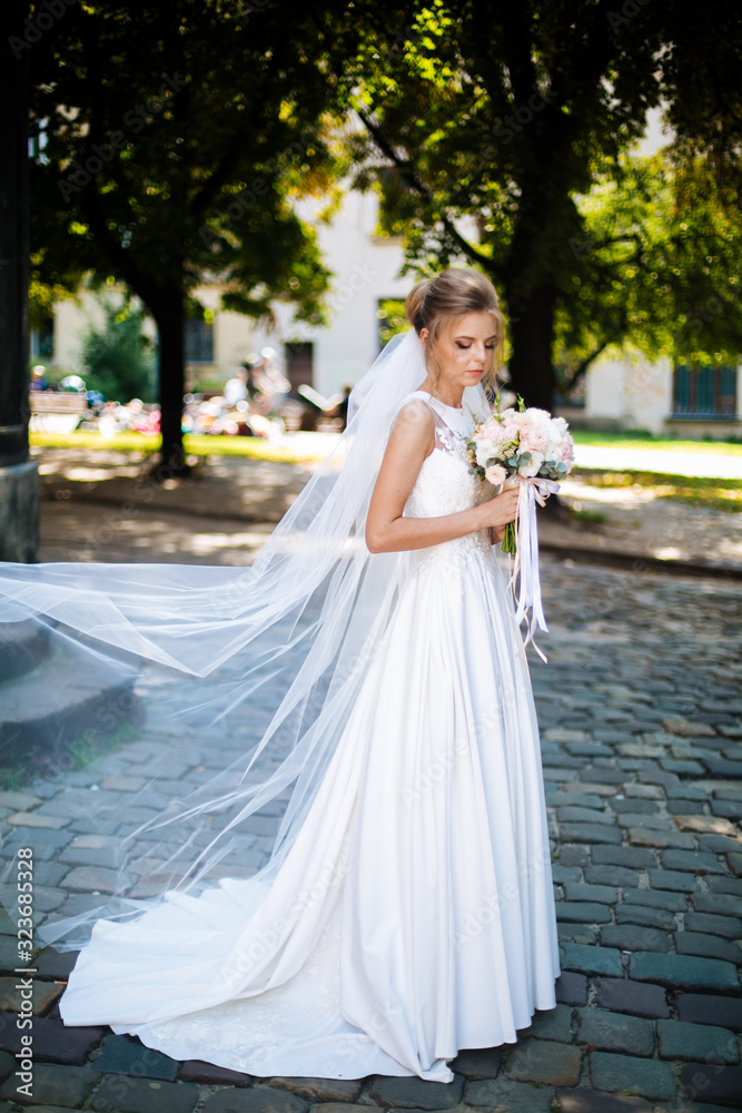bride full length holding a bouquet of flowers bride full length holding a bouquet of flowers