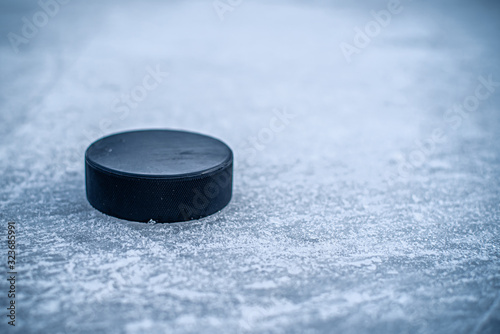 hockey puck lies on the snow close-up