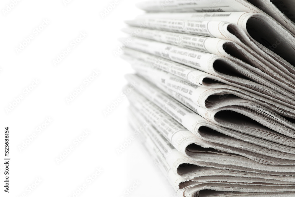 Stack of newspapers on white background, closeup. Journalist's work Stack of newspapers on white background, closeup. Journalist's work