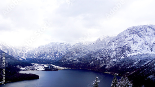 Scene of Hallstatt Winter snow mountain landscape valley and lake through the forest
