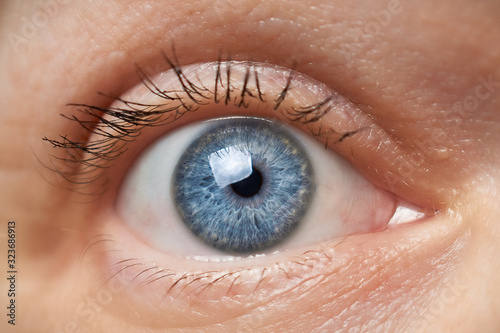 Fototapeta Naklejka Na Ścianę i Meble -  Close up of woman's eye with blue iris