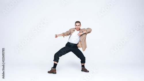 Young man dancing against white background