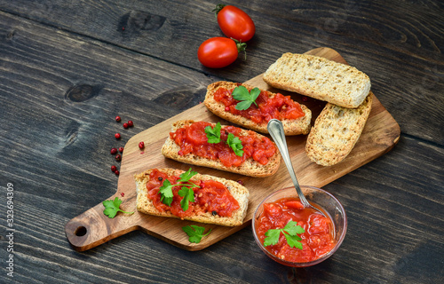 Obraz na plátně Italian bruschetta with tomatoes, olive oil, green parsley and pink pepper
