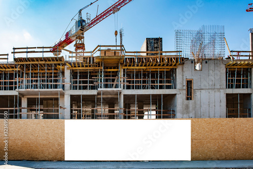 Blank white banner for advertisement on a fence of a building under construction photo