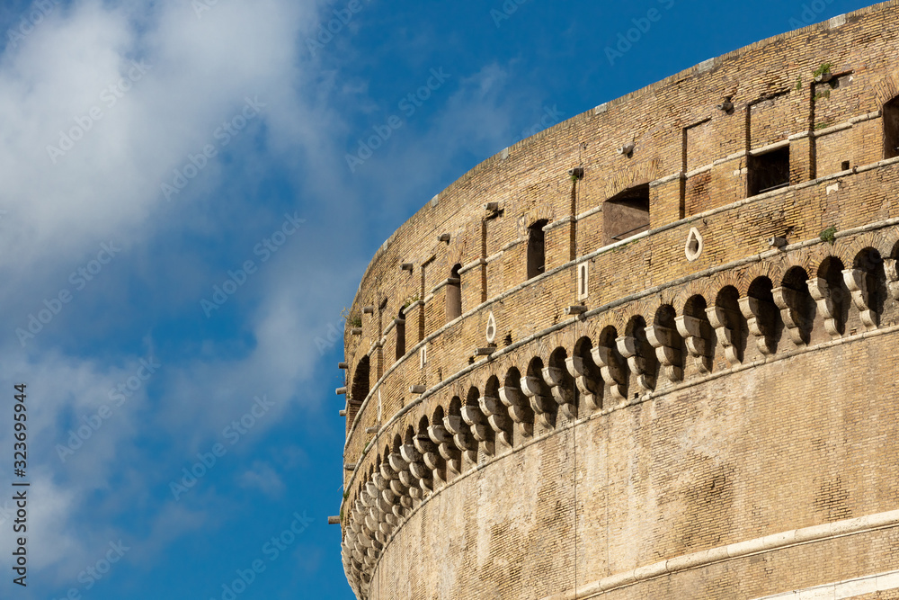 roman castle tower detail with blue sky and clouds background