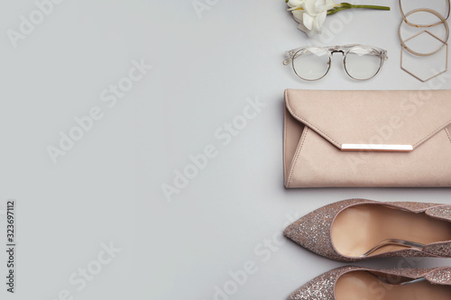 Flat lay composition with stylish woman's bag and accessories on grey background. Space for text