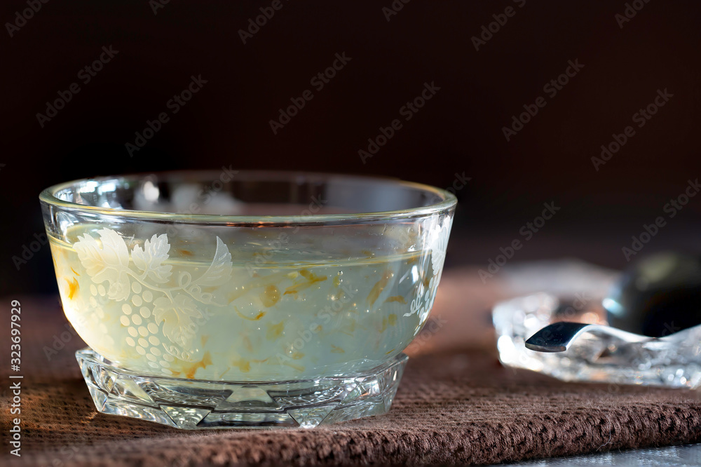 Bird's nest food in glass bowl clear on dark brown apron Bird's nest food in glass bowl clear on dark brown apron