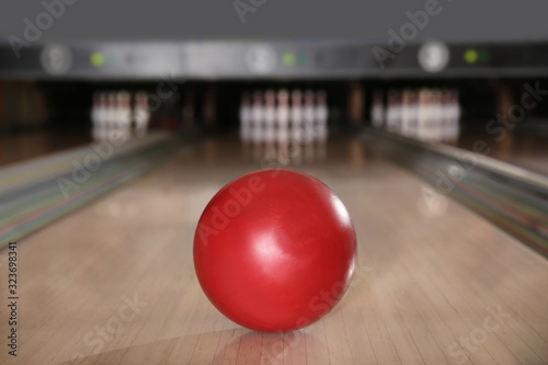 Red ball on bowling lane in club