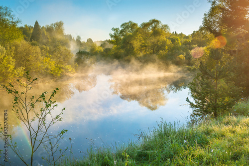 spring landscape with fog and river at sunrise