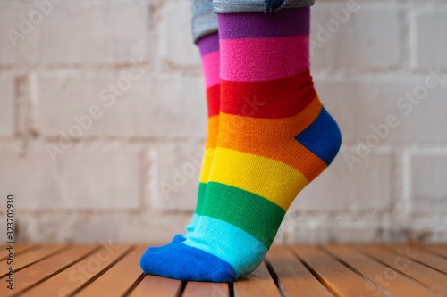 Feet standing on tiptoe with colored socks. photo