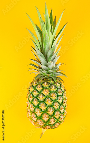 Fresh pineapple isolated on yellow background.