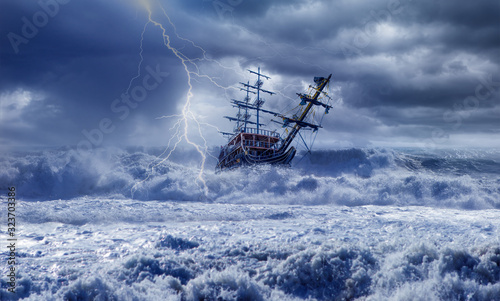 Sailing ship in storm sea on the background power sea wave with lightning