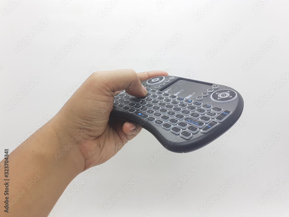 Modern Artistic Black TV Remote with QWERTY Keypad and Game Tools in White Isolated Background Modern Artistic Black TV Remote with QWERTY Keypad and Game Tools in White Isolated Background