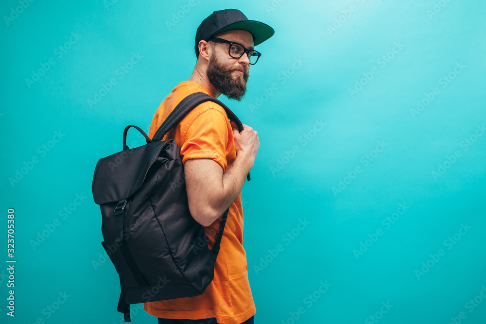 Handsome bearded hipster guy with black casual backpack, with space for your logo or design. Mockup for print. Travel concept. Handsome bearded hipster guy with black casual backpack, with space for your logo or design. Mockup for print. Travel concept.