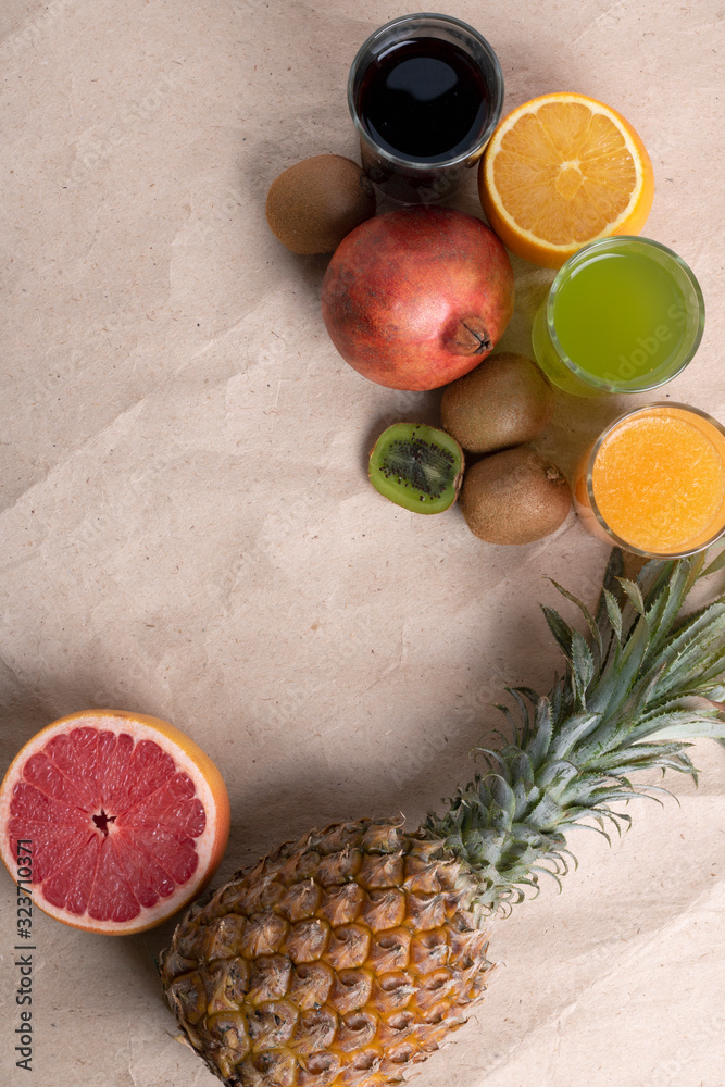 Exotic fruits on a gray background. Tropical fruits set on eco paper, zero waste Exotic fruits on a gray background. Tropical fruits set on eco paper, zero waste