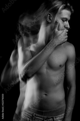 keep a secret. man closes his mouth with hand. Sexy man with naked torso. looking side. ignore or neglect emotions and feelings. Black and white long exposure photos series