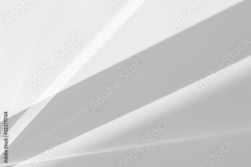Overlay effect for photo and mockups. Organic drop diagonal shadow and rays of light from window on a white wall.