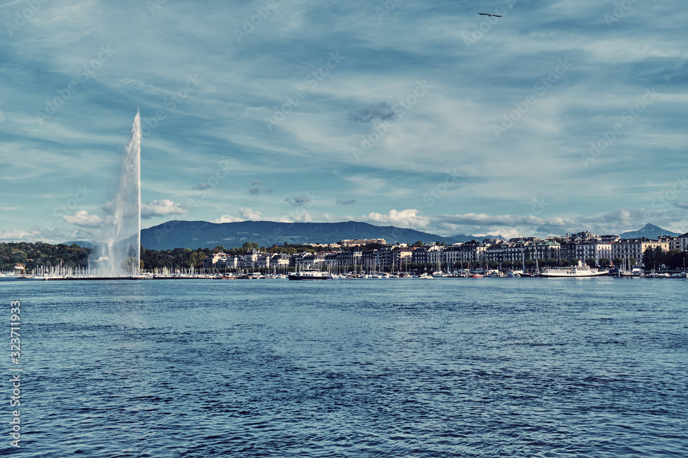 Cityscape with fountain and lake in Geneva.