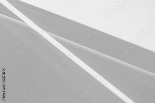 Overlay effect for photo and mockups. Organic drop diagonal shadow and rays of light from window on a white wall.