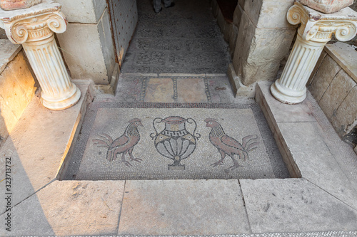 Mosaic on the floor at the entrance to the monastery of Gerasim Jordanian - Deir Hijleh - in the Judean desert near the city of Jericho in Israel photo