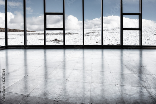 A platform of snow covered by a sheer mountain range