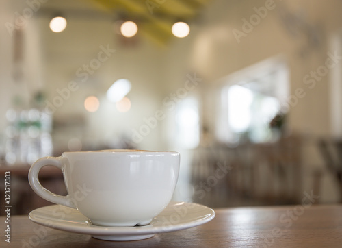 white coffee cup on table in shop.
