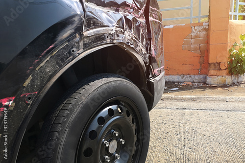 The side of the black car body that had an accident.Put spare wheel while waiting for repair