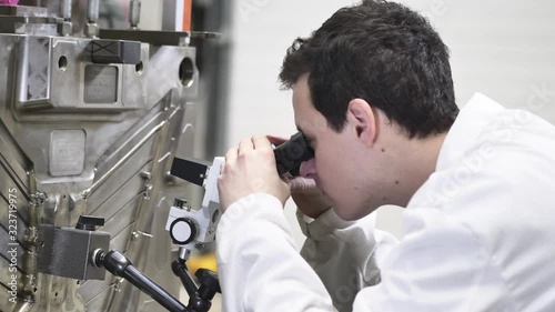 Quality Engineer Checks Deficiencies on the Injection Mold by a Microscope, Checking the Technical Condition of the Injection Mold in Automotive Factory, Industrial Concept