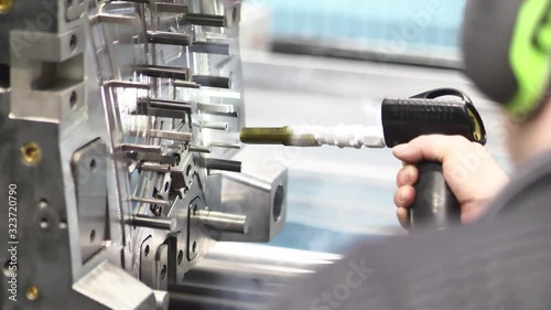 Service / Maintenance of Plastic Injection Mold during Production Freezing the Injection Mold using Dry Nitrogen Freezing Gun in Automotive Factory, Industrial Concept