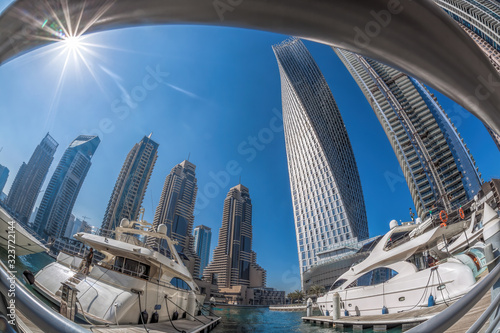 Dubai Marina with boats against skyscrapers in Dubai, United Arab Emirates photo