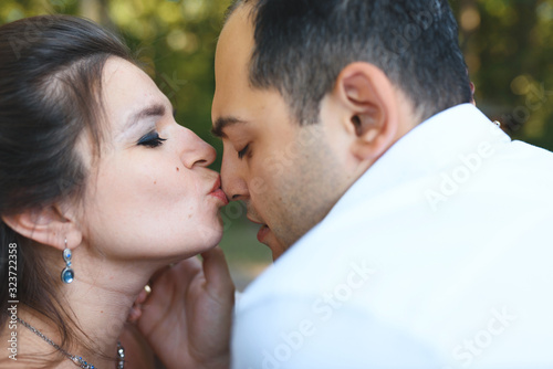woman kissing man in nose