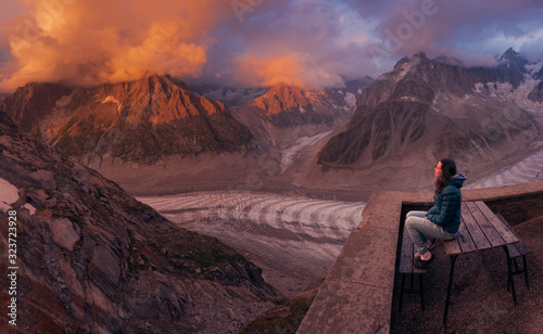 Young woman admiring the beautiful mountain sunset  view photo